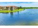 Scenic lake view showcases the lush green landscape and architecture of the surrounding community at 10061 Cozy Grove Dr, Venice, FL 34293