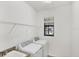 Laundry room with granite countertop over the sink, storage shelf, and a window that allows natural light at 10061 Cozy Grove Dr, Venice, FL 34293