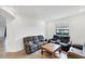 Cozy living room offers neutral colors, tile flooring, and comfortable furniture at 10061 Cozy Grove Dr, Venice, FL 34293