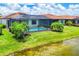 Inviting screened-in pool surrounded by lush landscaping in this home's backyard at 10061 Cozy Grove Dr, Venice, FL 34293