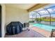 Outdoor patio features a grill, a screened-in pool, and a beautiful lake view at 10061 Cozy Grove Dr, Venice, FL 34293