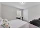 Neutral bedroom featuring a bed, a desk by the window, and closet doors at 11240 Spring Gate Trl, Bradenton, FL 34211