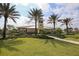 Beautiful community clubhouse surrounded by swaying palm trees and well-manicured landscaping for a relaxing outdoor area at 11240 Spring Gate Trl, Bradenton, FL 34211