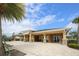 Covered outdoor patio with comfortable seating, perfect for relaxation and enjoying the community amenities in a serene setting at 11240 Spring Gate Trl, Bradenton, FL 34211