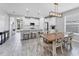 Dining area connected to the kitchen with bar stool seating and natural light at 11240 Spring Gate Trl, Bradenton, FL 34211