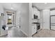 Welcoming entryway adjacent to a kitchen with white cabinets and stainless steel appliances at 11240 Spring Gate Trl, Bradenton, FL 34211
