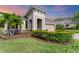 Charming single-Gathering home featuring a manicured lawn, tropical landscaping, and a stone-accented facade at 11240 Spring Gate Trl, Bradenton, FL 34211