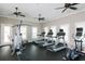 Well-equipped gym area with modern machines, ceiling fans, and natural light for a healthy lifestyle and comfortable workouts at 11240 Spring Gate Trl, Bradenton, FL 34211