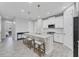 Open kitchen featuring a large island with seating, pendant lights, and modern white cabinetry at 11240 Spring Gate Trl, Bradenton, FL 34211