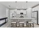 Bright kitchen featuring a large center island with pendant lighting and modern white cabinetry at 11240 Spring Gate Trl, Bradenton, FL 34211