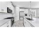 Modern kitchen with white cabinets, subway tile backsplash, and stainless steel appliances at 11240 Spring Gate Trl, Bradenton, FL 34211