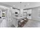 Bright kitchen features an island with seating, white cabinets, and modern stainless steel appliances at 11240 Spring Gate Trl, Bradenton, FL 34211
