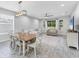 Open floor plan showcasing living room with view to backyard from adjacent dining area at 11240 Spring Gate Trl, Bradenton, FL 34211