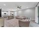 Spacious living area with a large sectional sofa adjacent to the kitchen and dining area at 11240 Spring Gate Trl, Bradenton, FL 34211