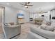 Open-concept living room features comfortable seating and flows into the dining area and kitchen at 11240 Spring Gate Trl, Bradenton, FL 34211