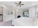 Comfortable and bright main bedroom features a dresser and sliding glass door to backyard at 11240 Spring Gate Trl, Bradenton, FL 34211