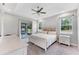 Bedroom features sliding glass doors to the screened in patio and view to green backyard at 11240 Spring Gate Trl, Bradenton, FL 34211