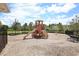 A community playground featuring a slide and swingset with a wood chip groundcover at 11240 Spring Gate Trl, Bradenton, FL 34211