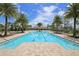 Large community swimming pool surrounded by palm trees, comfortable lounge chairs, and a relaxing outdoor atmosphere at 11240 Spring Gate Trl, Bradenton, FL 34211
