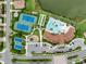 Overhead view of a community clubhouse, pool, playground, tennis courts, and surrounding lush landscaping at 11560 Tapestry Ln, Venice, FL 34293