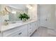 Bright bathroom with double vanity, modern lighting, and a full mirror at 11560 Tapestry Ln, Venice, FL 34293