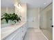 Bright bathroom with double vanity, modern lighting, and a frameless glass shower at 11560 Tapestry Ln, Venice, FL 34293