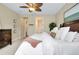 Well-lit bedroom featuring a ceiling fan, plush carpet, and decorative furniture at 11560 Tapestry Ln, Venice, FL 34293