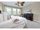 Comfortable bedroom with natural light, ceiling fan, carpet flooring, and decorative furniture at 11560 Tapestry Ln, Venice, FL 34293