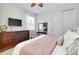 Comfortable bedroom featuring a bed, side table, and closet at 11560 Tapestry Ln, Venice, FL 34293