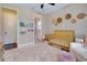 Well-decorated Bedroom with a stylish rug, crib, and adjacent bathroom with unique shower curtain at 11560 Tapestry Ln, Venice, FL 34293