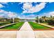 Bocce ball court surrounded by lush landscaping near a scenic pond at 11560 Tapestry Ln, Venice, FL 34293