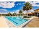 Community pool with palm trees and sunny skies at 11560 Tapestry Ln, Venice, FL 34293