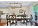 Dining room with hardwood floors, chandelier, mirror, and buffet at 11560 Tapestry Ln, Venice, FL 34293