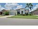 Charming single-story home with a well-manicured lawn, beautiful landscaping, and a two-car garage at 11560 Tapestry Ln, Venice, FL 34293