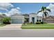 Charming single-story home with a well-manicured lawn, beautiful landscaping, and a two-car garage at 11560 Tapestry Ln, Venice, FL 34293