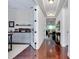 Hallway boasting gleaming wood floors with natural light and french doors leading to the office at 11560 Tapestry Ln, Venice, FL 34293