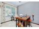 Bright home office featuring a light grey accent wall, a wooden desk, and a plush rug at 11560 Tapestry Ln, Venice, FL 34293
