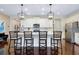 Kitchen featuring a spacious island with bar seating, stainless appliances, and white cabinetry at 11560 Tapestry Ln, Venice, FL 34293