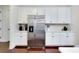 Bright kitchen with stainless steel refrigerator and white cabinetry at 11560 Tapestry Ln, Venice, FL 34293