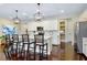 Beautiful kitchen with white cabinets, pendant lighting, and a center island with seating at 11560 Tapestry Ln, Venice, FL 34293