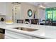 Kitchen island featuring a stainless steel sink and views into the dining area at 11560 Tapestry Ln, Venice, FL 34293
