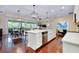 Kitchen island featuring stainless steel dishwasher, cabinets, and seating at 11560 Tapestry Ln, Venice, FL 34293