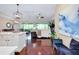 Open-concept living room showcasing beautiful hardwood floors and screened-in porch at 11560 Tapestry Ln, Venice, FL 34293