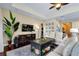 Bright living room with tray ceilings, wood floors and stylish furniture is perfect for entertaining at 11560 Tapestry Ln, Venice, FL 34293