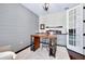Bright office featuring stylish desk, shiplap accent wall, and French door entry at 11560 Tapestry Ln, Venice, FL 34293