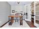 Office with light grey shiplap wall, rustic industrial desk, and french doors leading to hallway at 11560 Tapestry Ln, Venice, FL 34293