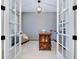 Office with French doors, shiplap accent wall, light-colored rug, and bright light fixture at 11560 Tapestry Ln, Venice, FL 34293