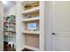 Pantry with shelving, wood floors, and storage space at 11560 Tapestry Ln, Venice, FL 34293