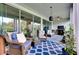 Relaxing covered lanai featuring plush seating, a blue patterned rug, and beautiful outdoor views at 11560 Tapestry Ln, Venice, FL 34293