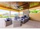 Cozy outdoor patio with stone fireplace and comfortable seating at 11560 Tapestry Ln, Venice, FL 34293
